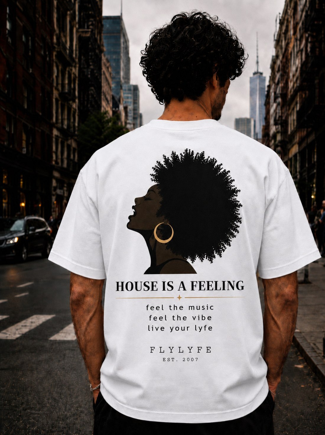 Man wearing white FLYLYFE Soul Tee, a house-is-a-feeling shirt with a soulful afro-silhouette back print on a garment-dyed Comfort Colors blank