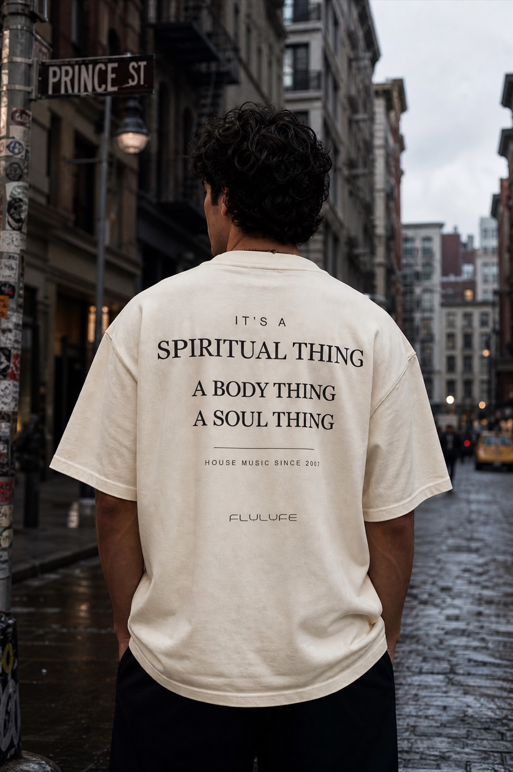 FLYLYFE Spiritual Thing tee — house manifesto back print, worn on a model in NYC